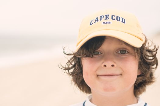 Young boy smiling on the beach in Cape Cod