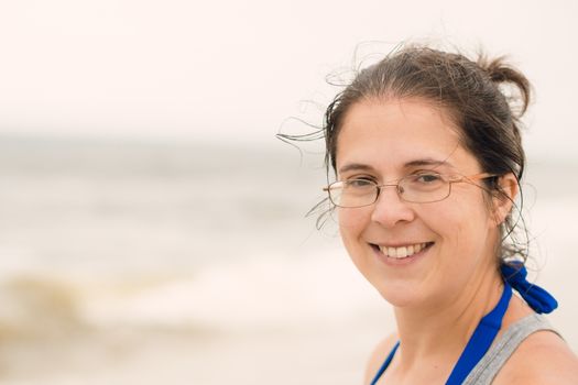 Woman smiling on the beach in Cape Cod