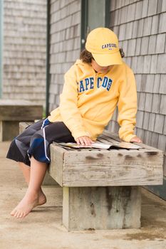 Boy reading outside in Cape Cod