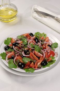 Cherry tomato salad with olives, capers and cilantro