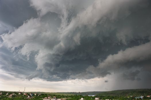 Beginning of the  storm with small tornado above the village