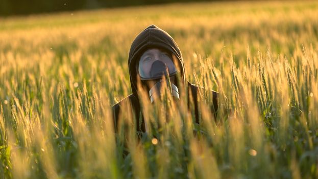 Allergic man with gasmask at the field