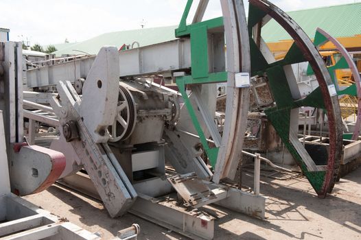 Warehouse old oil pumpjacks stand in row