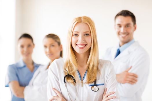 attractive female doctor in front of medical group