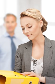 picture of a young attractive businesswoman with folders