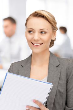 picture of happy woman with big notepad