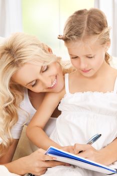 picture of mother and daughter doing home work