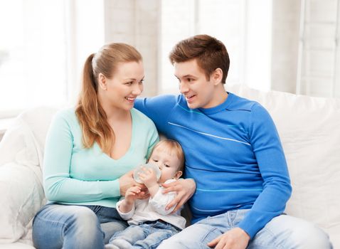 happy family and adorable baby with feeding-bottle