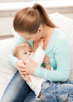 happy mother and adorable baby with feeding-bottle