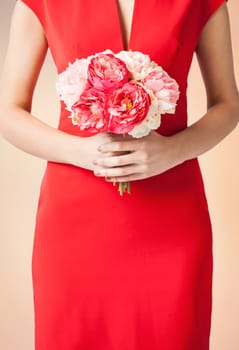 close up of woman hands with bouquet of flowers