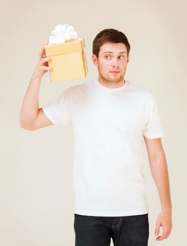 picture of man in white t-shirt with gift box