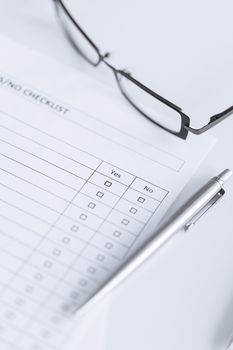 close up of blank questionnaire or form with eyeglasses