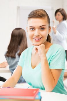 picture of happy smiling student girl with books at school