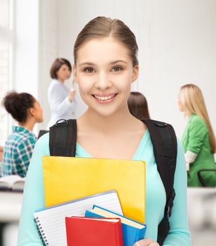 happy student girl with school bag and notebooks at school