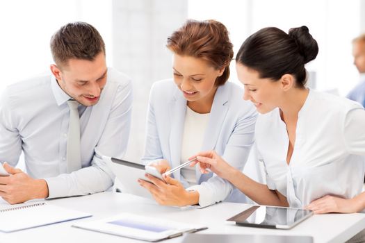 smiling business team working with tablet pcs in office