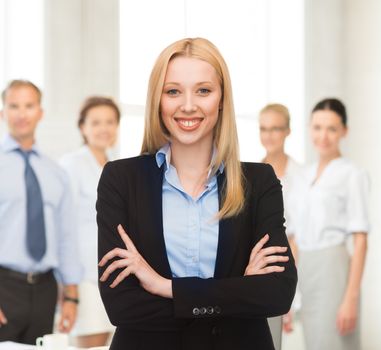 picture of friendly young smiling businesswoman in office