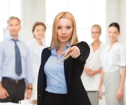 picture of attractive businesswoman pointing her finger at you