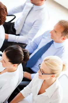 picture of smiling businessmen and businesswomen on conference