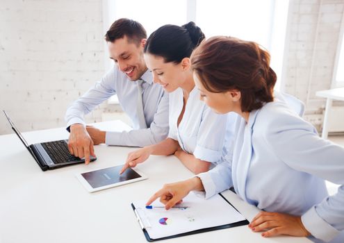 business concept - business team working with tablet pc and laptop in office