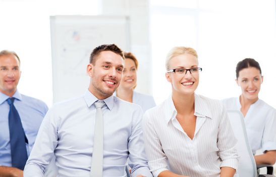 picture of smiling businessmen and businesswomen on conference