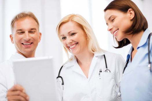 healthcare and technology concept - doctors looking at tablet pc