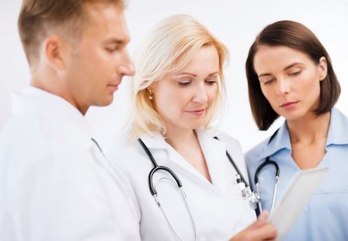 healthcare and technology concept - doctors looking at tablet pc