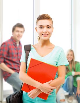 education concept - smiling student girl with folders and school bag