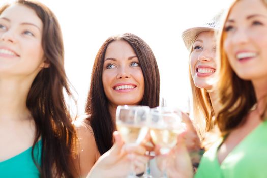 summer holidays, vacation and celebration - girls with champagne glasses