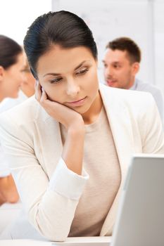 business and communication concept - businesswoman with laptop computer at work