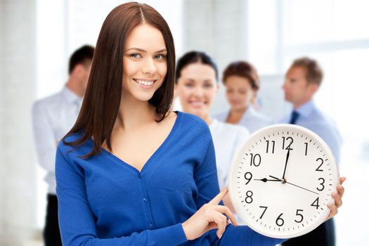 business and time management concept - businesswoman pointing at alarm clock