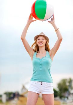 summer holidays, vacation and beach activities - girl playing ball on the beach