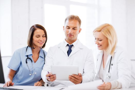 healthcare, medical and technology concept - doctors looking at tablet pc