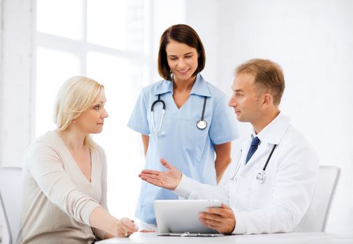 healthcare, medical and technology - doctor showing something to patient on tablet pc