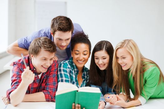 education concept - students reading book at school