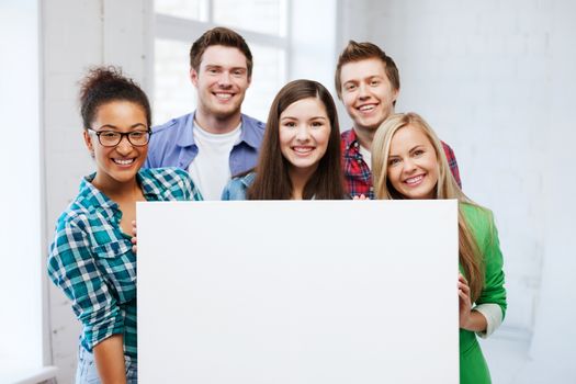 education concept - group of students at school with blank white board