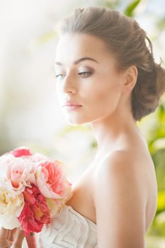 wedding and beauty concept - young woman with bouquet of flowers