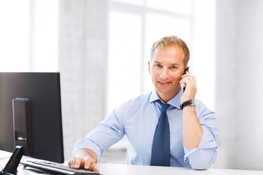 business and technology concept - smiling businessman with smartphone in office