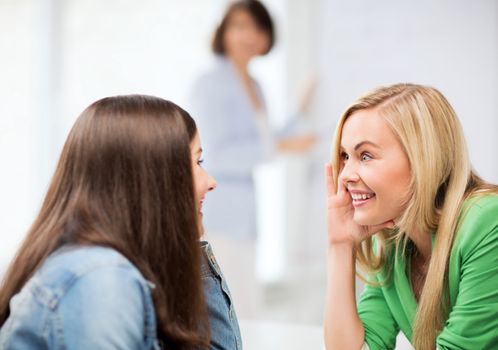 education concept - student girls gossiping at school