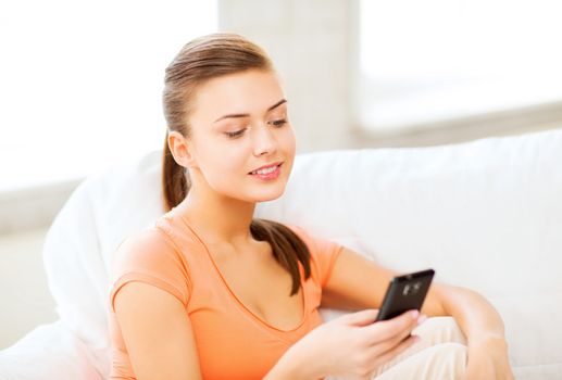 home, communication and internet - woman sitting on the couch with smartphone at home