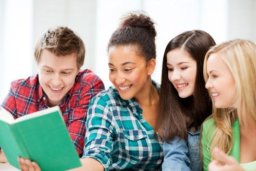 education concept - group of students reading book at school