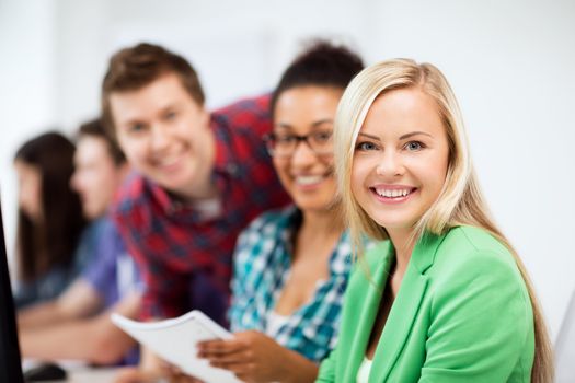 education, technology and internet - students with computer studying at school