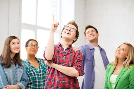 education concept - student boy with group of students at school