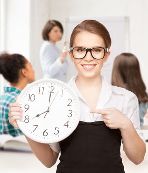 education and time management - attractive student pointing at clock