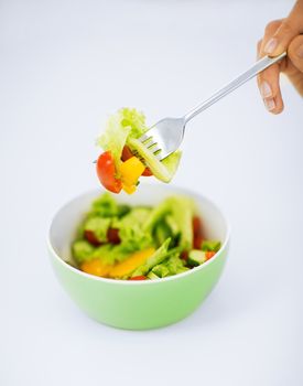 healthy food and kitchen concept - bowl of salad with vegetables