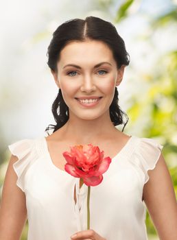 wedding and beauty concept - young woman with flower