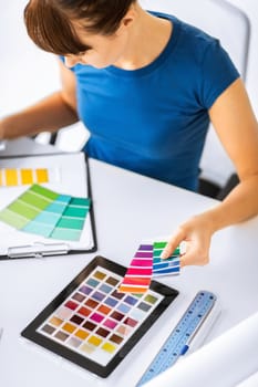 interior design, renovation and technology concept - woman working with color samples for selection