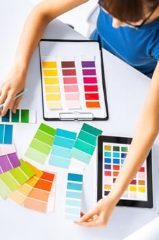 interior design, renovation and technology concept - woman working with color samples for selection