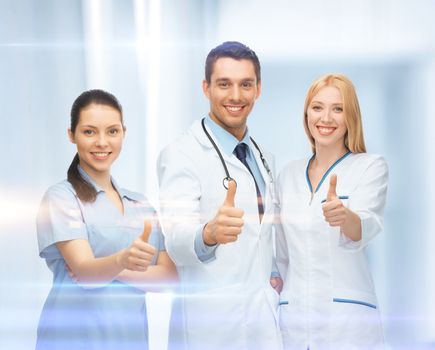 healthcare and medical - professional young team or group of doctors showing thumbs up