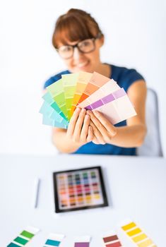 interior design, renovation and technology concept - woman working with color samples for selection