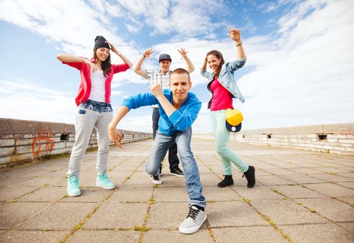 sport, dancing and urban culture concept - group of teenagers dancing